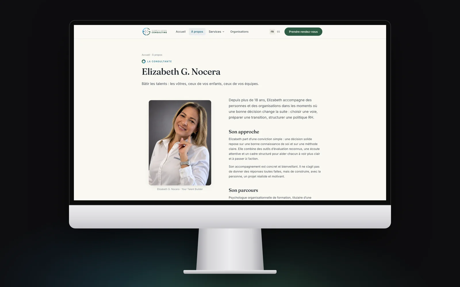 iMac showing the About page: Elizabeth’s portrait beside her approach and background.